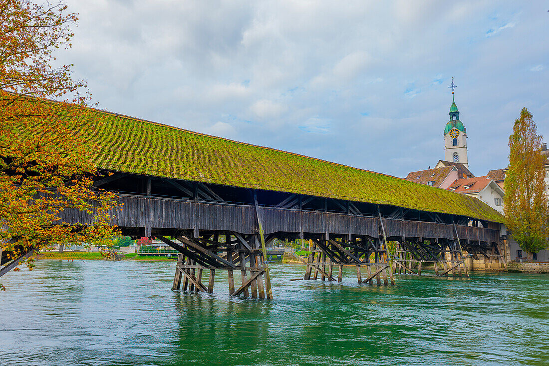 Old Town and the Historical Covered Wood Bridge Holzbrücke over River Aare in a Sunny Day with Clouds in Olten, Canton Solothurn, Switzerland.