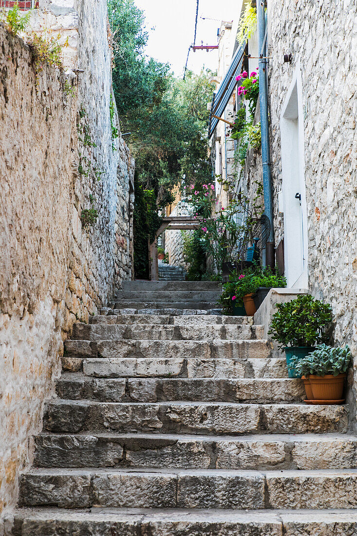  Narrow street with old stone houses in Croatia 