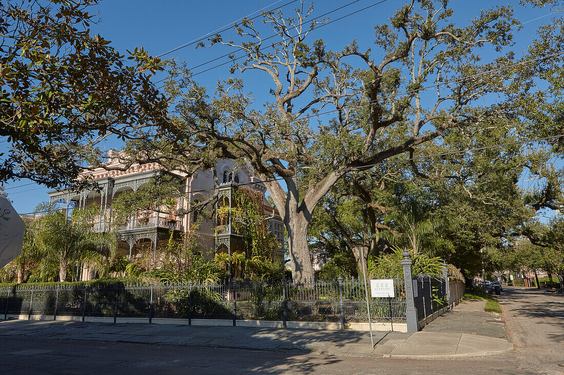 Exterior view of a posh house surrounded by lush greenery in the Garden District of New Orleans city, Louisiana, USA.