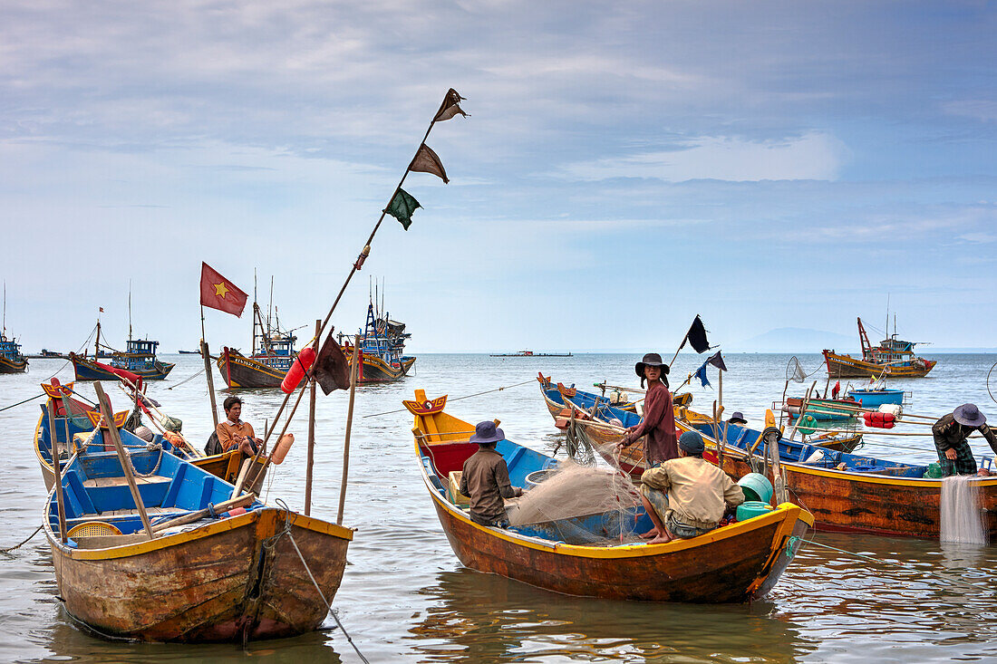 Traditional fishing boats moored in Mui Ne Fishing Harbor. Mui Ne, Binh Thuan Province, Vietnam.