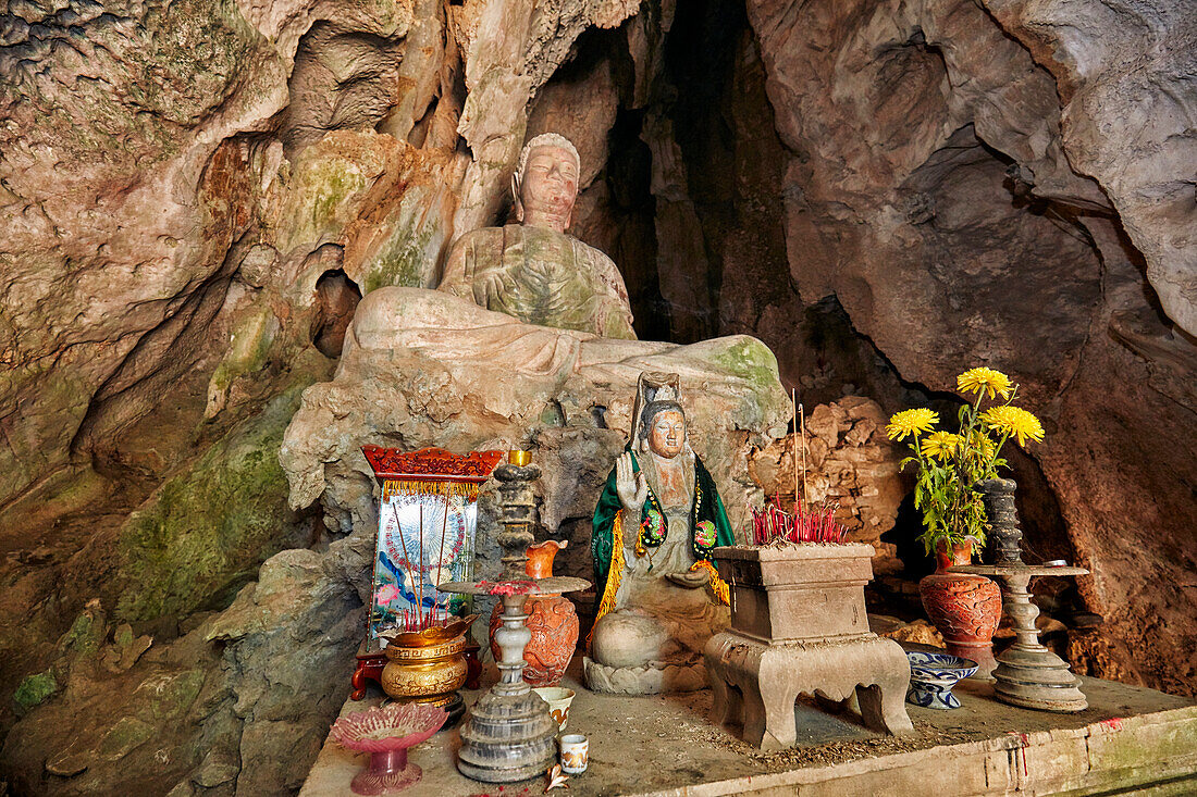 Seated Buddha statue in Tang Chon Cave. Thuy Son Mountain, The Marble Mountains, Da Nang, Vietnam.