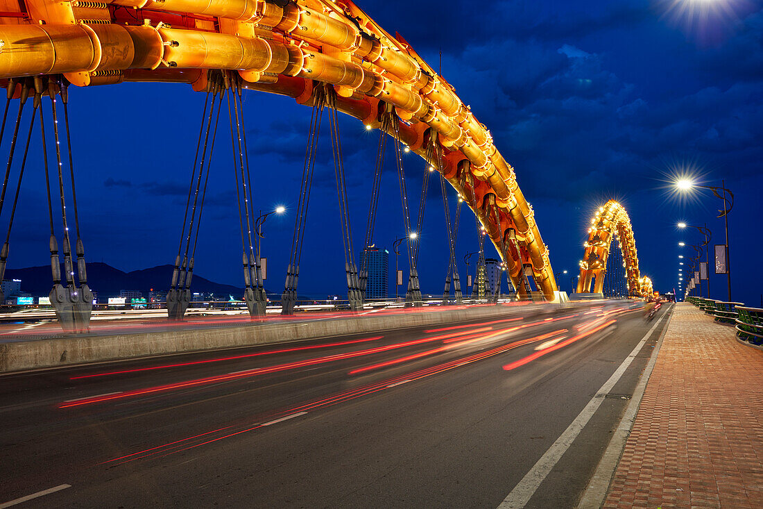 Dragon Bridge (Cau Rong) over the River Han illuminated at night. Da Nang city, Vietnam.