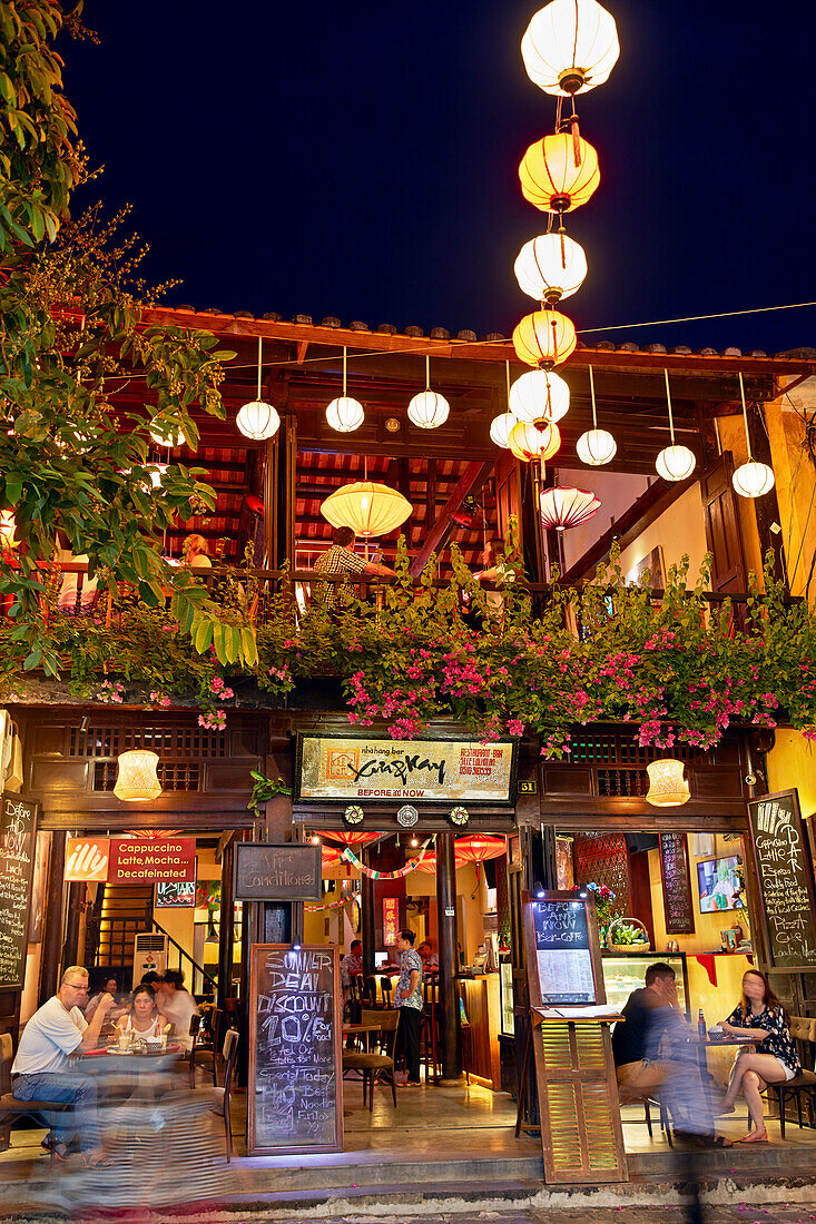 Exterior view of a restaurant in Hoi An Ancient Town illuminated at dusk. Quang Nam Province, Vietnam.