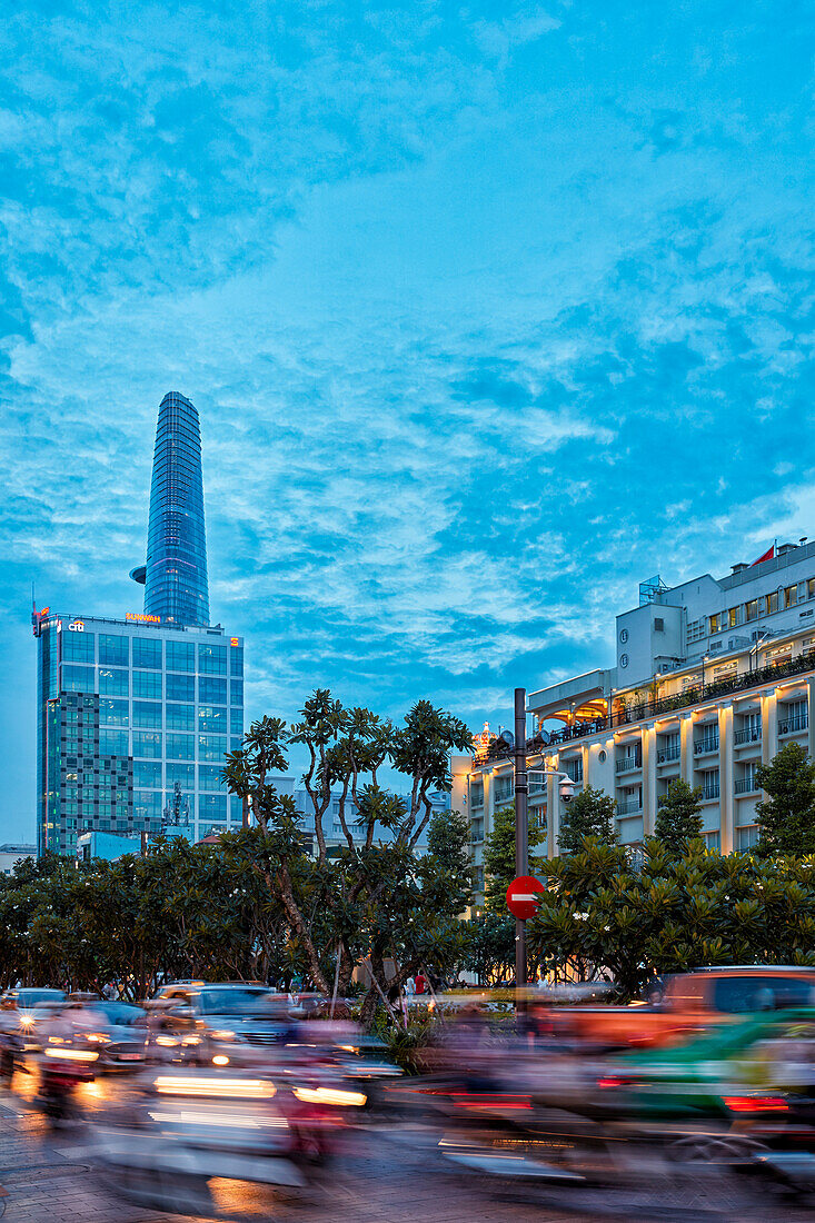 Cars move in Nguyen Hue street at dusk. District 1, Ho Chi Minh City, Vietnam.