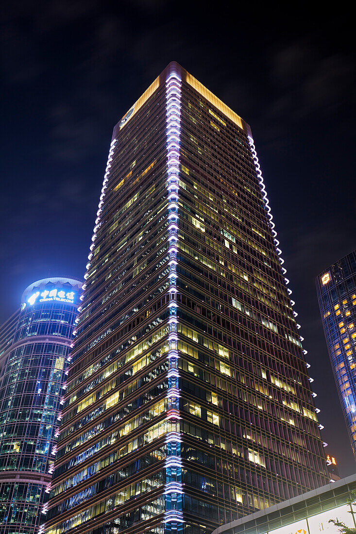 Exterior view of the skyscrapers in Futian Central Business District illuminated at night. Shenzhen, Guangdong Province, China.