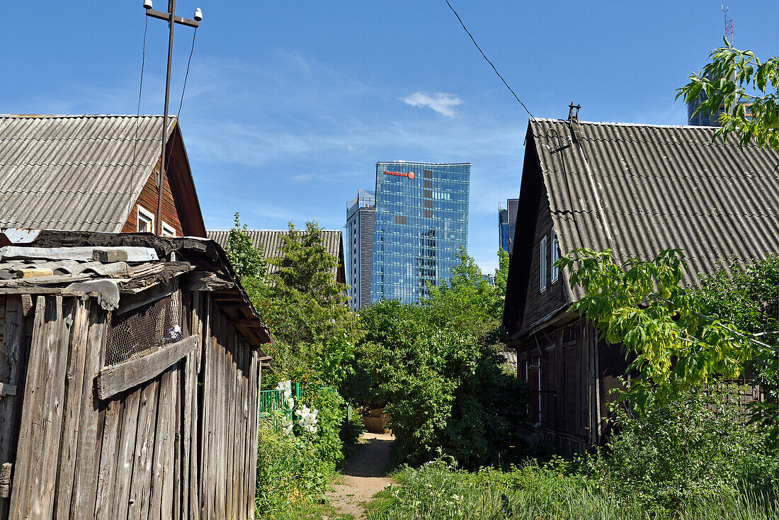 old wooden houses surrounded by modern office towers in the Snipiskes district, Vilnius, Lithuania, Europe