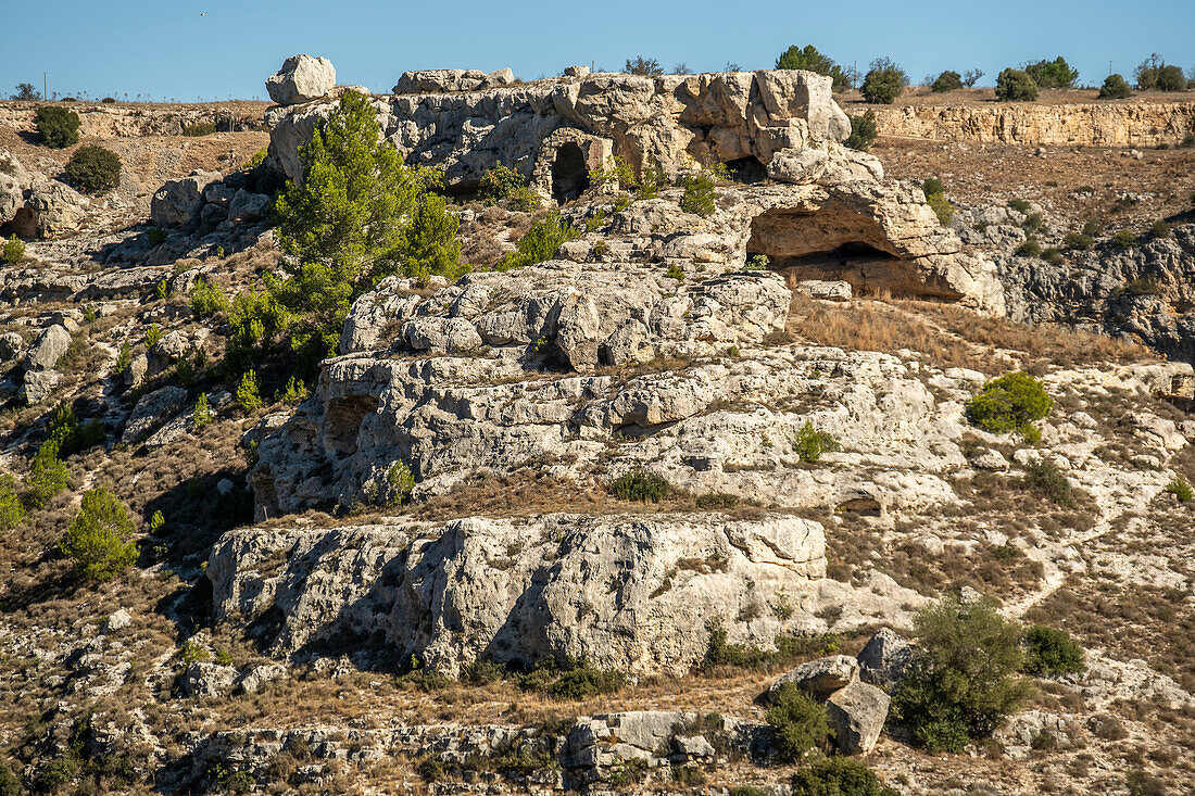 Ancient cave dwellings on the side of the Murgia Materana park (Parco della Murgia Materana), Matera, Basilicata, Italy.