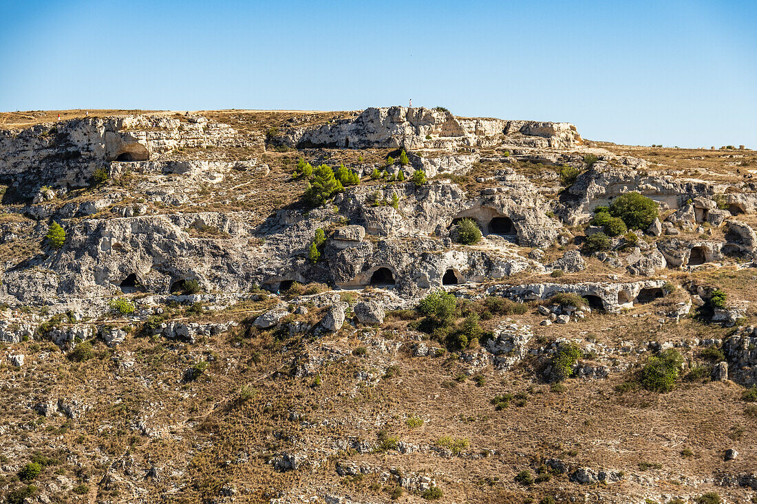 Ancient cave dwellings on the side of the Murgia Materana park (Parco della Murgia Materana), Matera, Basilicata, Italy.