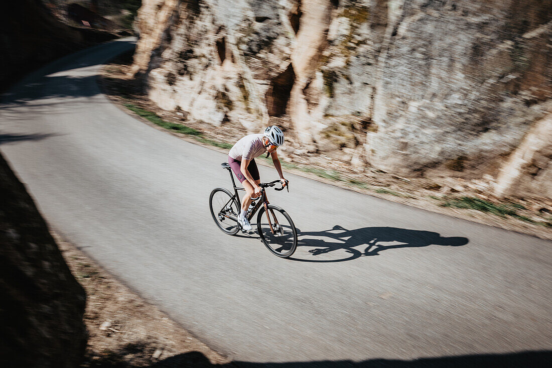 Road biking, woman riding a racing bike on the road