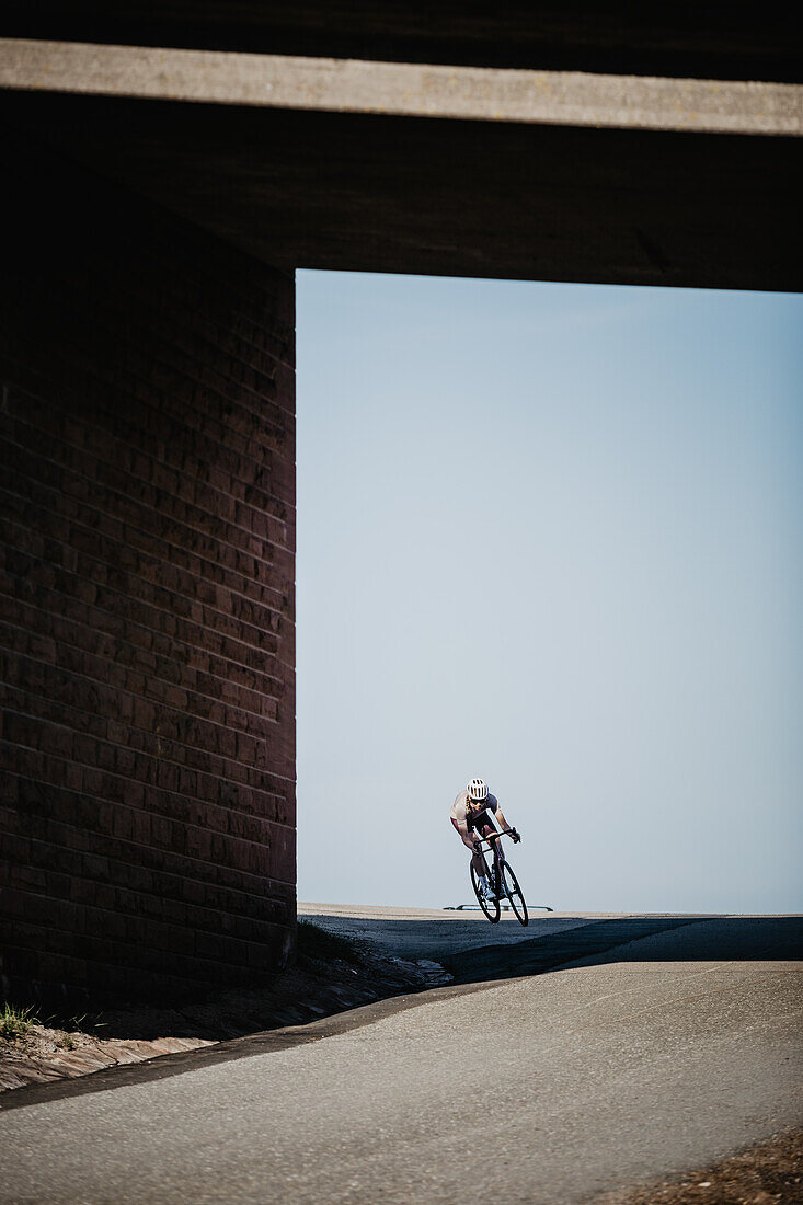 Road biking, woman riding a racing bike on the road