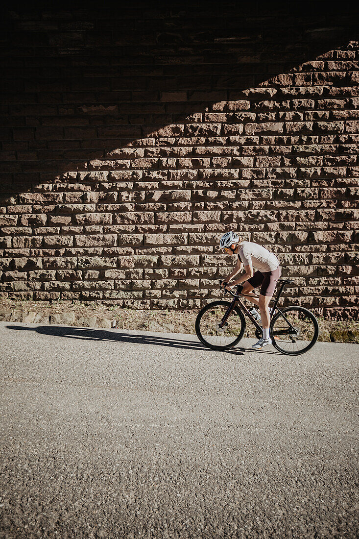 Road biking, woman riding a racing bike on the road