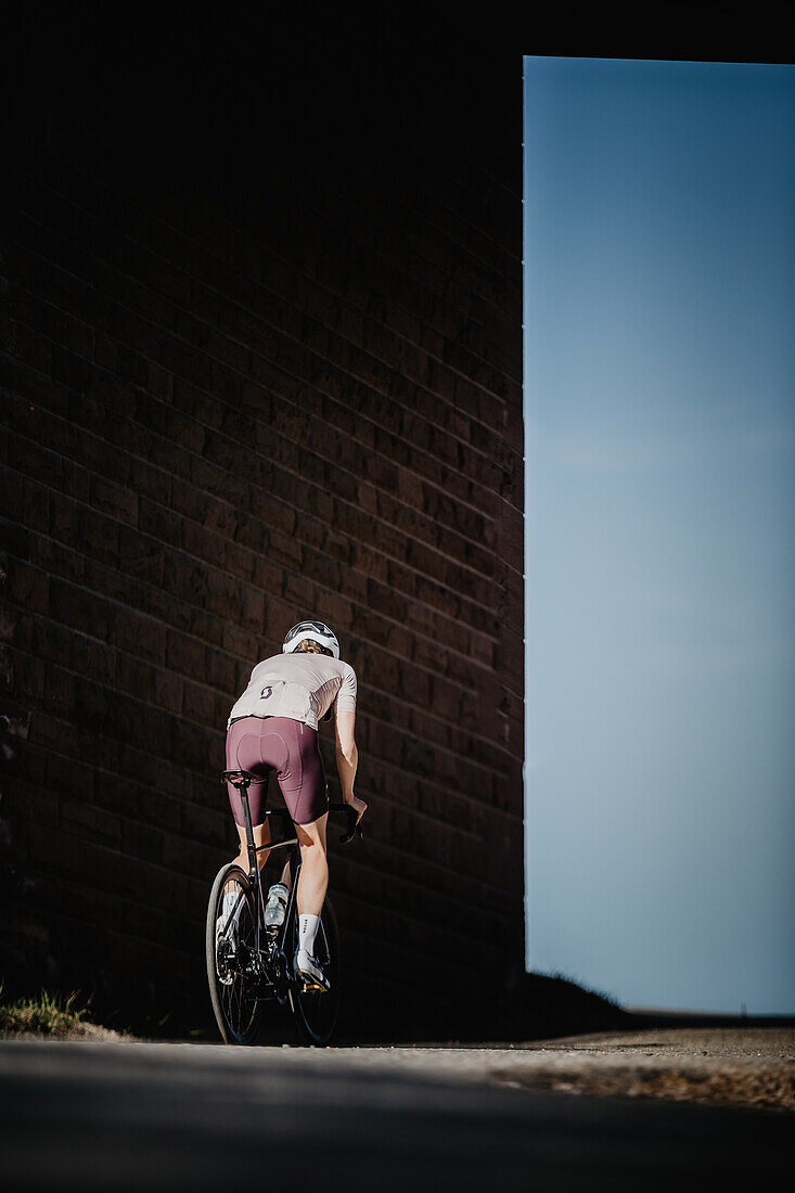 Road biking, woman riding a racing bike on the road