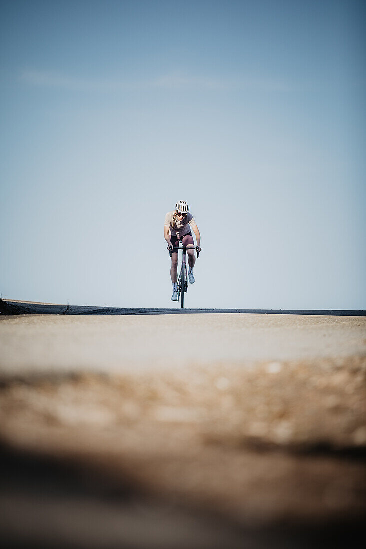 Road biking, woman riding a racing bike on the road