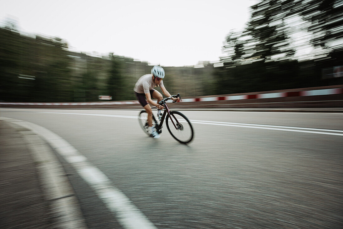 Road biking, woman riding a racing bike on the road