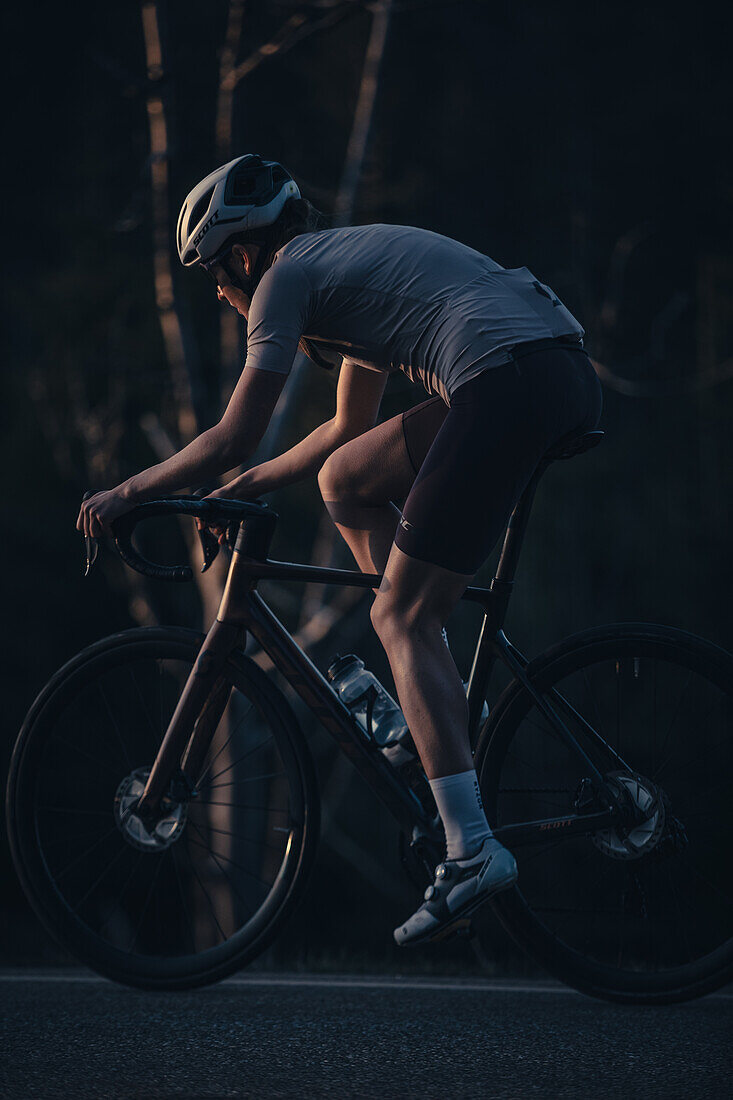 Road biking, woman riding a racing bike on the road