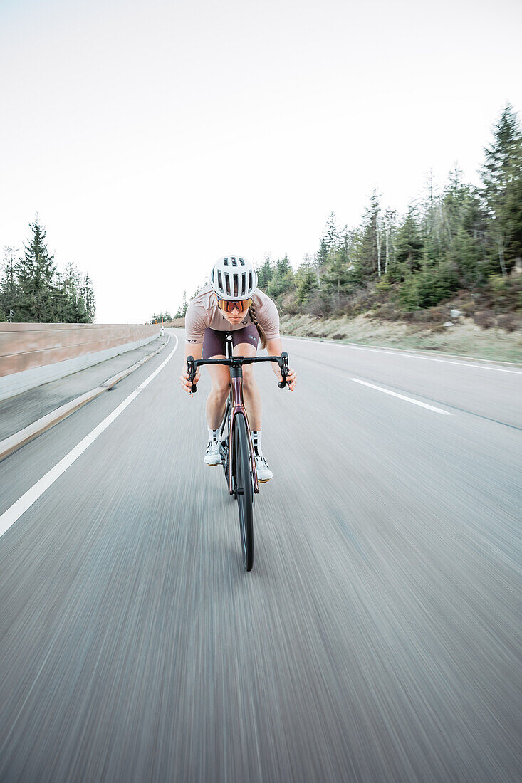 Road biking, woman riding a racing bike on the road