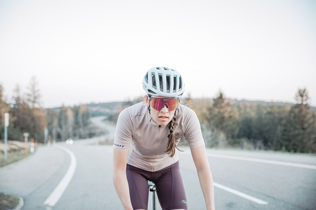 Road biking, woman riding a racing bike on the road