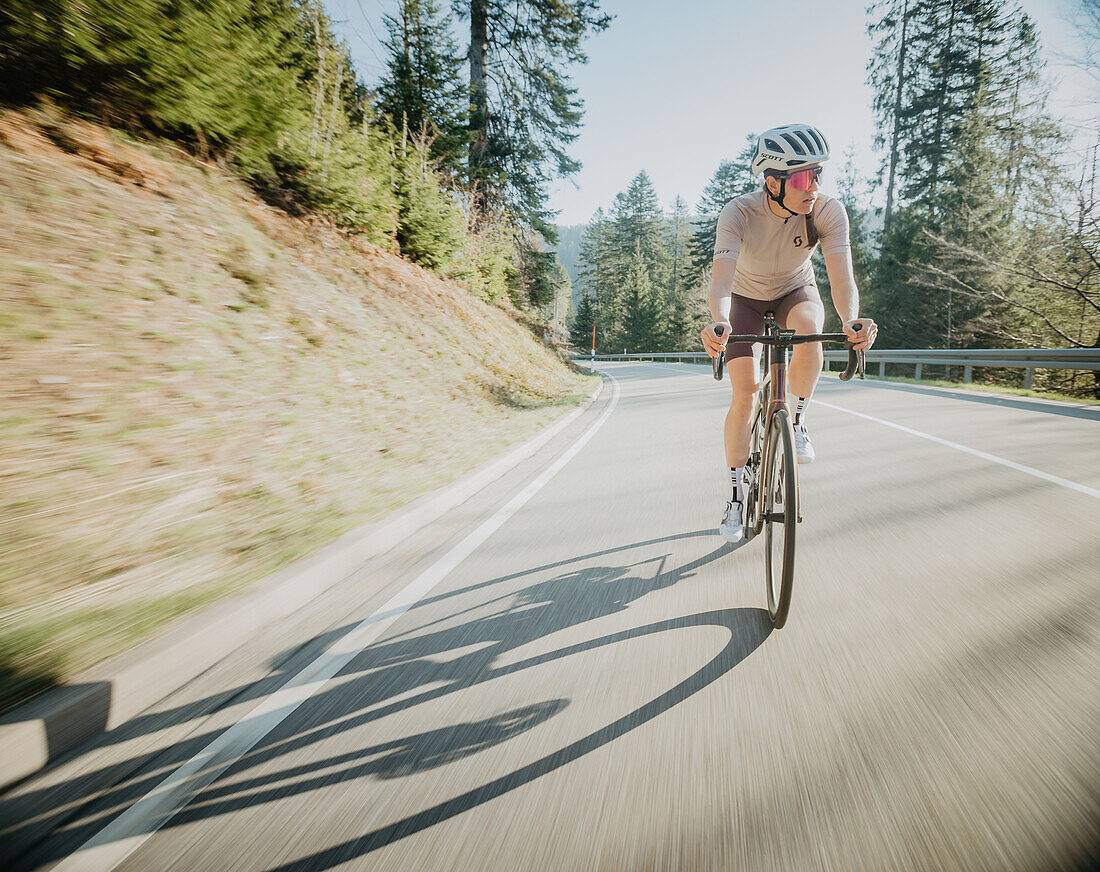 Road biking, woman riding a racing bike on the road