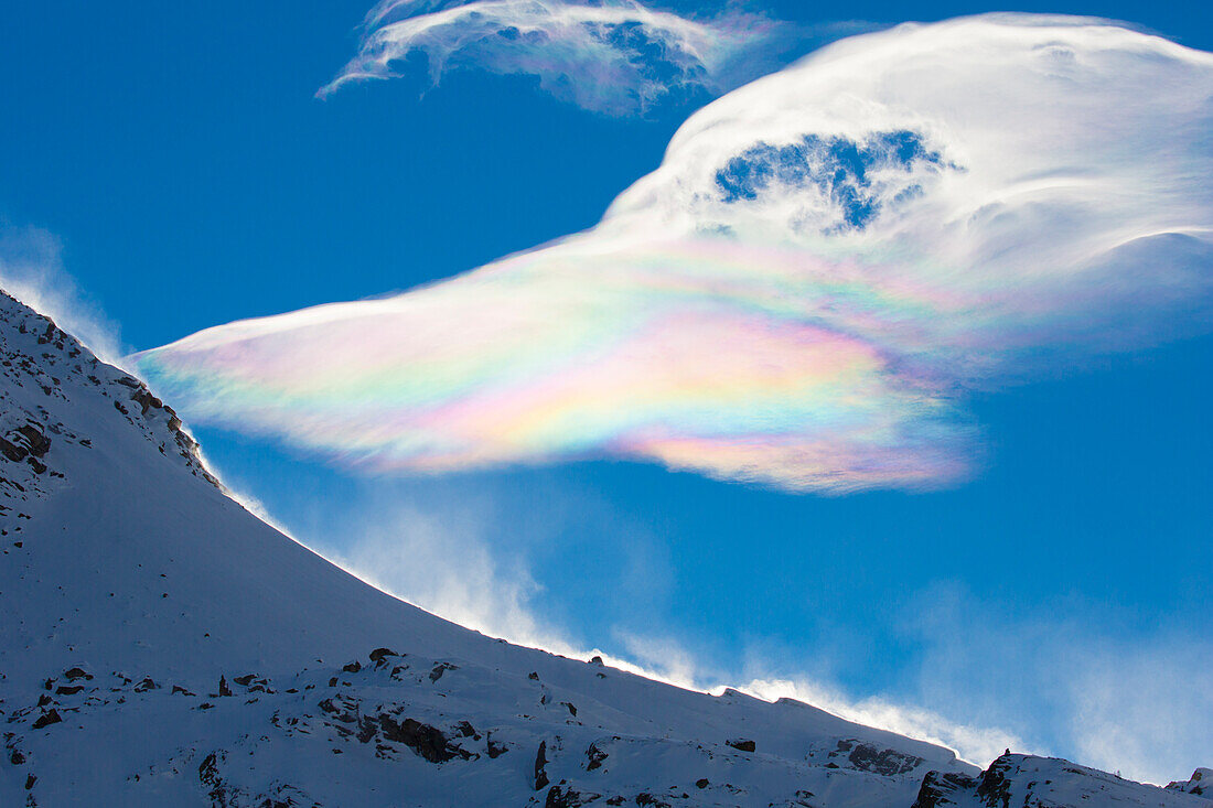  Spectral colors in a cloud on the mountain Cima dell Arolley, Gran Paradiso National Park, Aosta Valley, Italy 