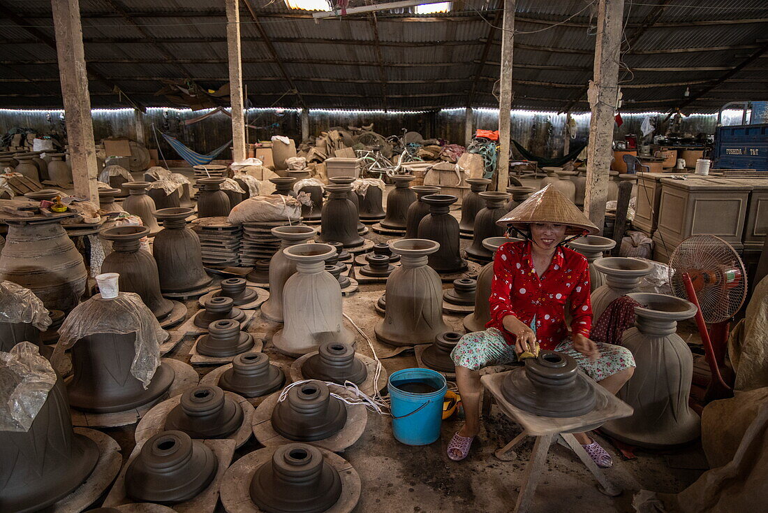  Woman wearing traditional Vietnamese conical hat making pottery in a factory, Long Son, Phu Tan, An Giang, Vietnam, Asia 