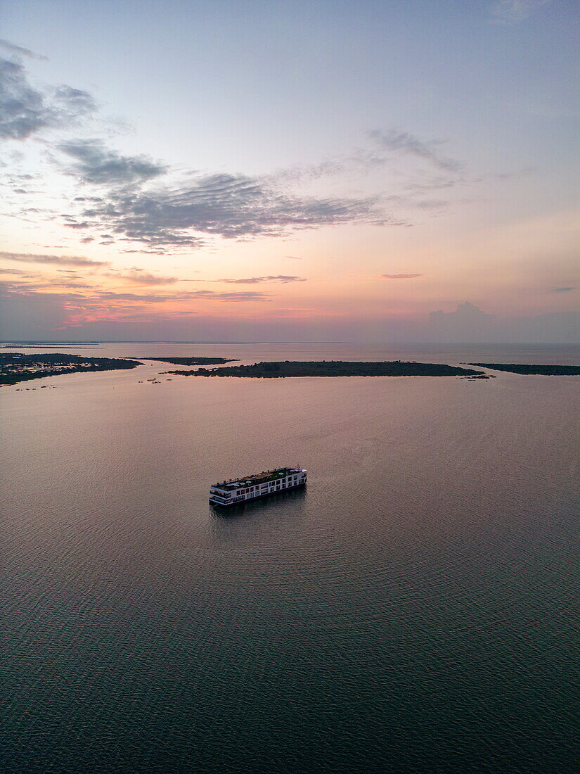  Aerial view of river cruise ship RV Mekong Discovery (Thurgau Travel) on Tonle Sap Lake at dusk, Srae Sdok, Kandieng District, Pursat, Cambodia, Asia 