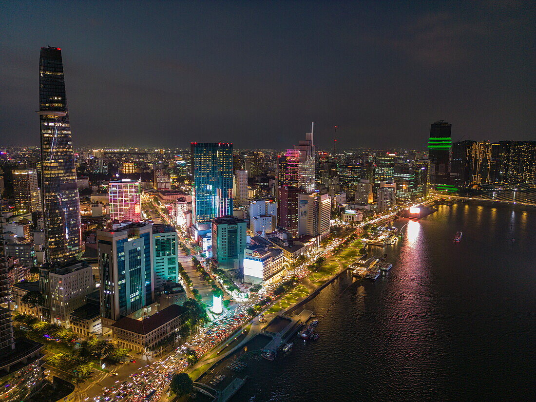  Aerial view of rush hour traffic along Saigon River with skyscrapers in downtown District 1 at night, Quan 4, Ho Chi Minh City, Vietnam, Asia 