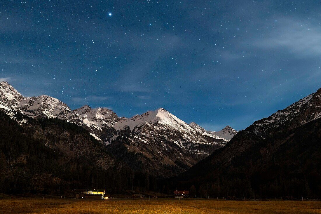  Mountain landscape, winter landscape, starry sky over snow-covered mountain peaks, stars, pasture, Stillachtal, summit, Alps, Oberallgäu, Bavaria, Germany\n 