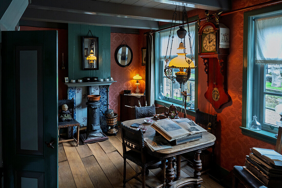 A vintage room with antique furniture, including a grandfather clock, wooden table with books, and a fireplace. The room is dimly lit with old-fashioned lamps and has a cozy, nostalgic atmosphere.