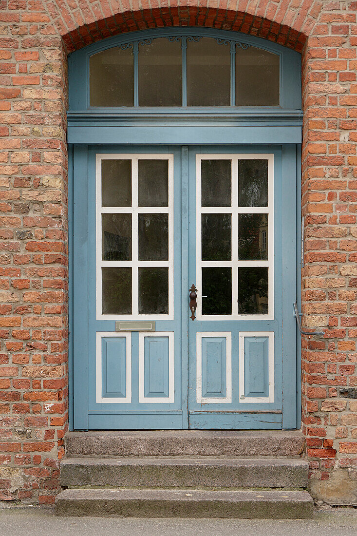  Front door old turquoise and white on brick facade 