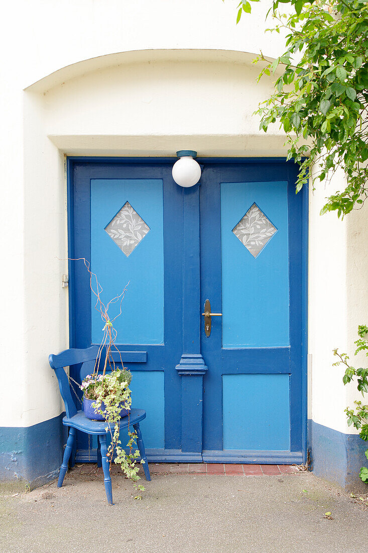  Old blue front door and chair as decoration 