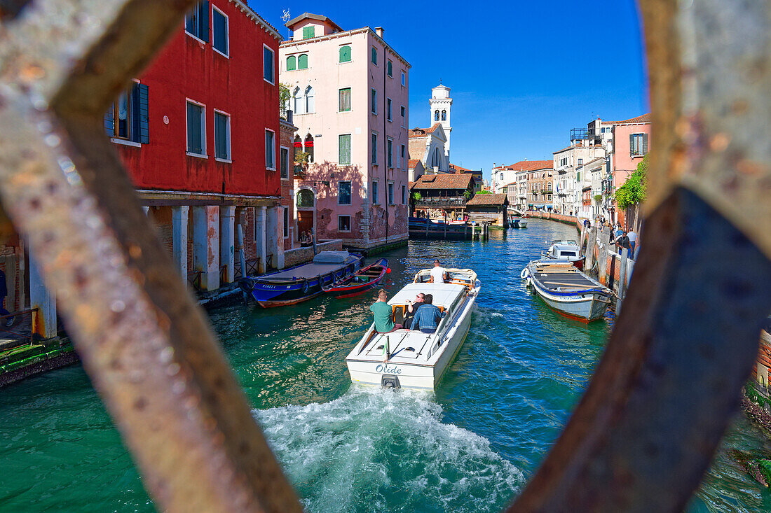  Tourists on a tour boat in a side canal, Venice, Veneto, Italy 