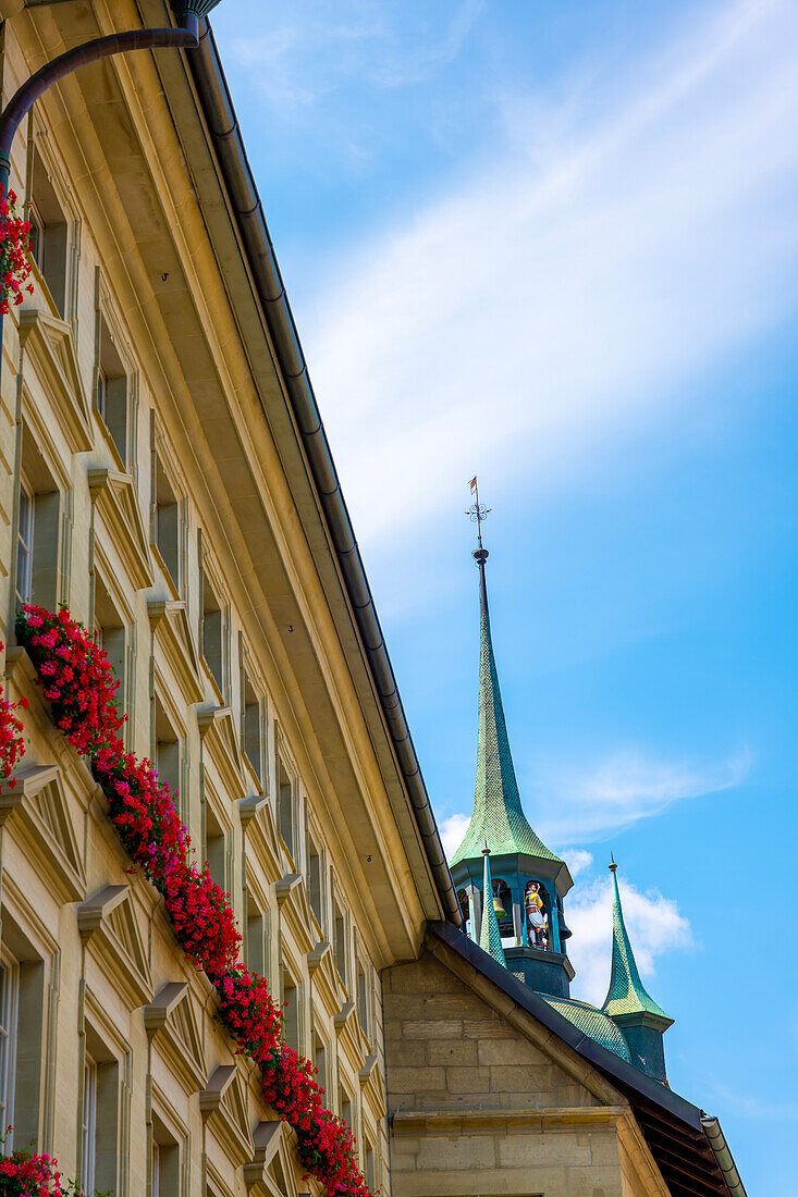 City Hall with Clock Tower and Flowers in a Sunny Summer Day in City of Fribourg, Canton Fribourg, Switzerland.