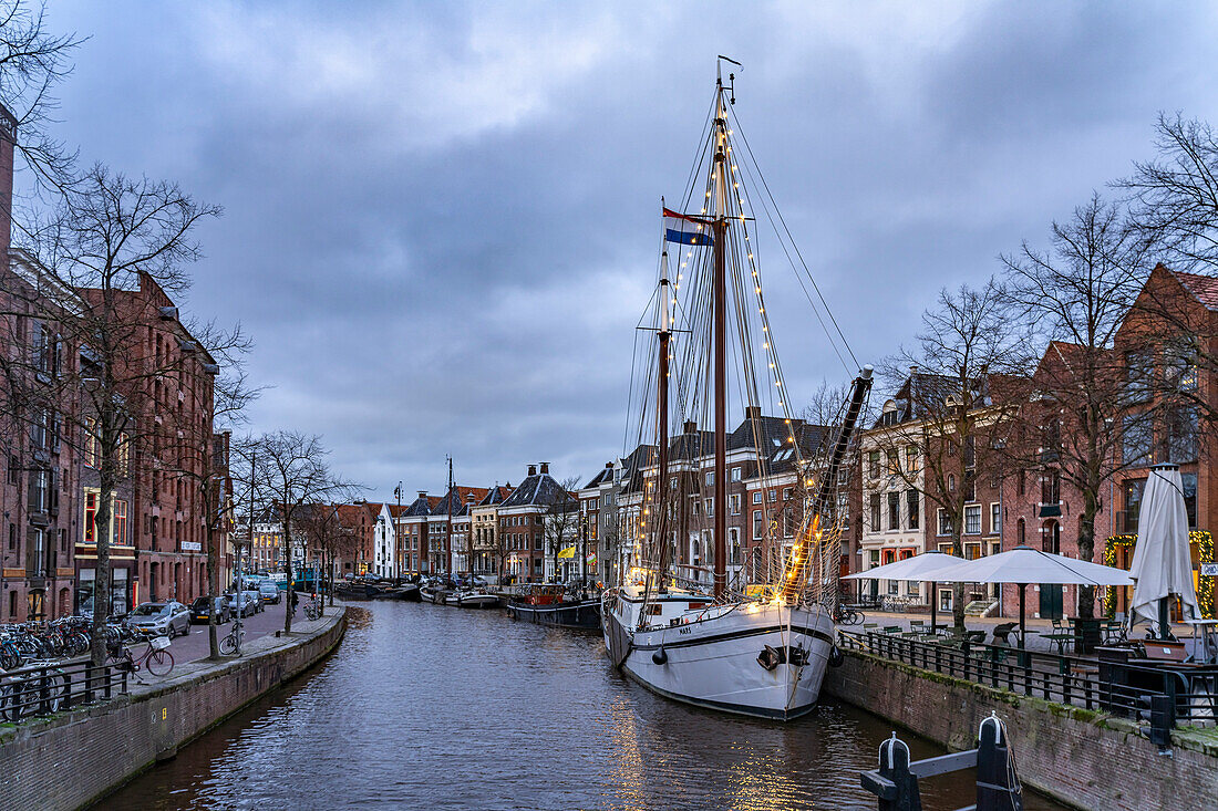  Typical canal with sailing boats in Groningen at dusk, Netherlands  