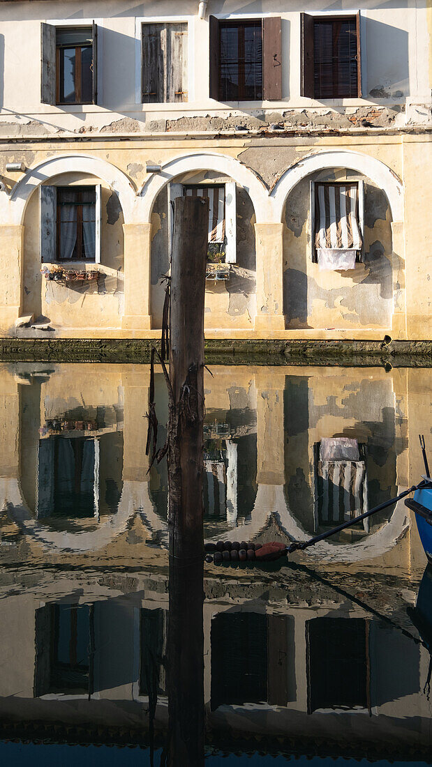  View of the Vena Canal with its reflections of the old facades, Chioggia, Venice Lagoon, Veneto, Italy, Europe 