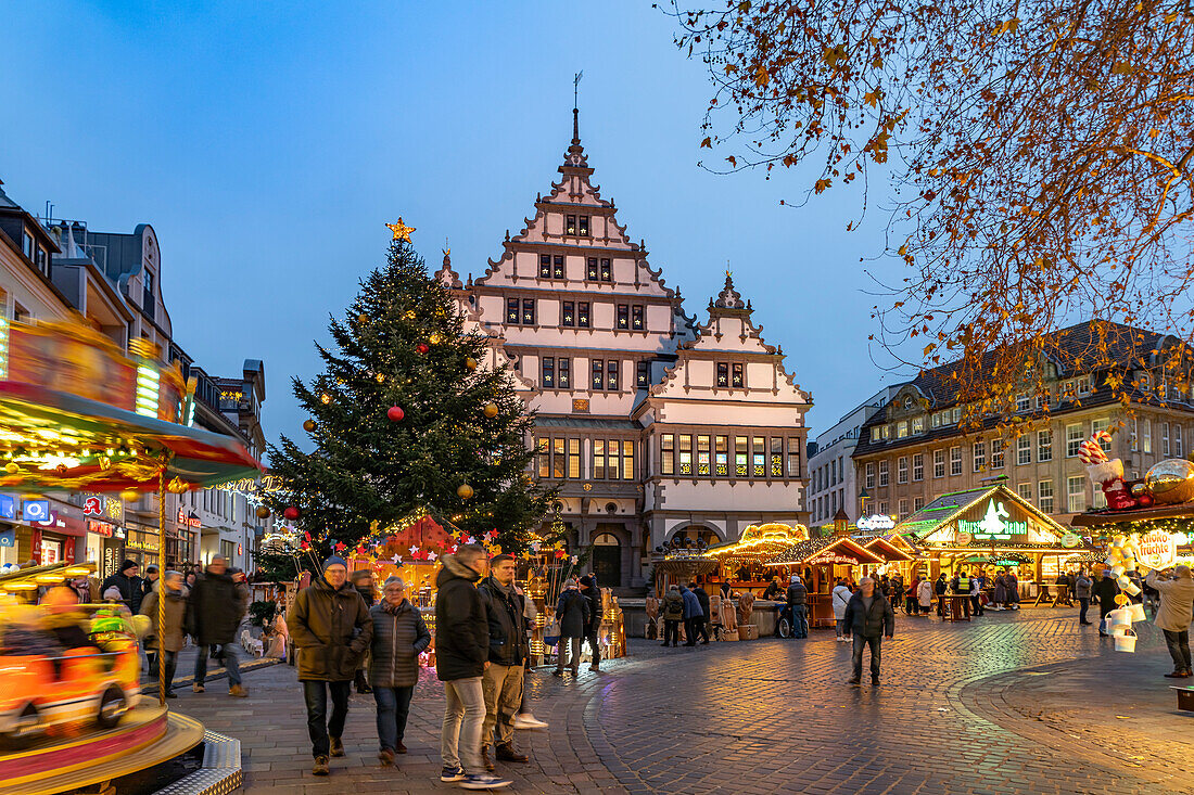  Christmas market at the colorfully illuminated Paderborn town hall at dusk in Paderborn, North Rhine-Westphalia, Germany, Europe 