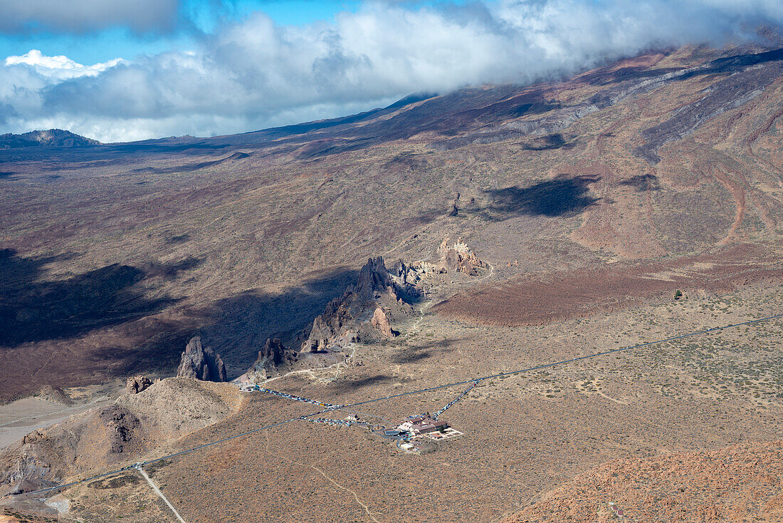  Panorama during the ascent to Alto de Guajara, 2715m, to the bizarrely shaped rock formations made of volcanic rock, Roques de García, the visitor center and the Hotel Parador, at sunrise, Teide National Park, Parque Nacional del Teide, Tenerife, Canary Islands, Spain, Europe 