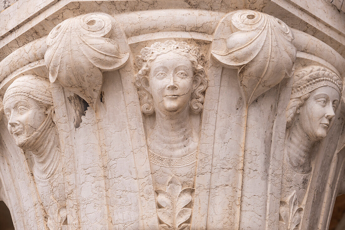 Detail of one of the Column Capitals at the Doge's Palace, Piazzetta di San Marco, Venice, Italy. This capital of Latin women, under the influence of Mars and Jupiter; comprises a series of female heads, whose head-ware and hair styles reflect their age and social status.