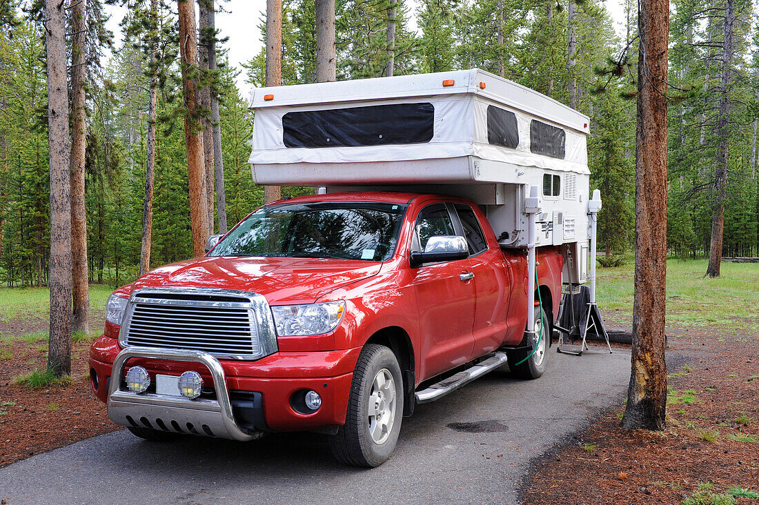  Red pickup truck with pop-up camper at campsite in Grand Canyon National Park, Arizona, USA 