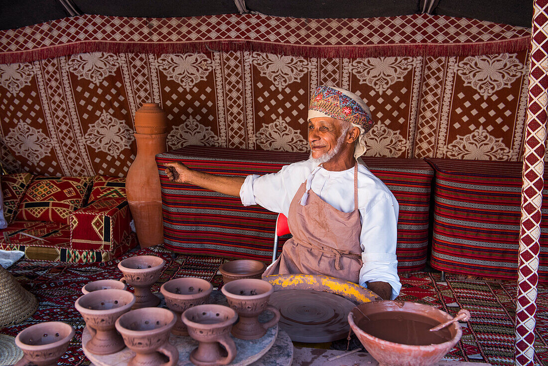 Salih potter, making a demonstration of his craft in the enclosure of the Fort of Nizwa, Ad Dakhiliyah Region, Sultanate of Oman, Arabian Peninsula, Middle East