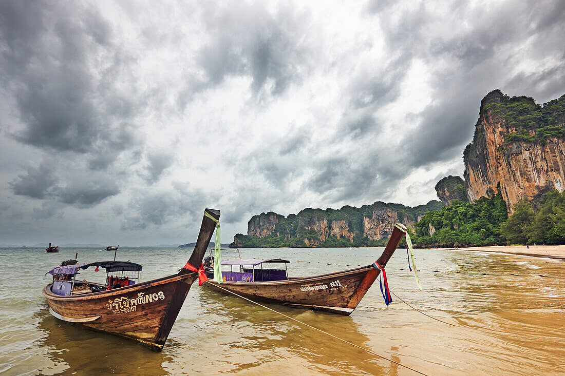 Traditional Thai long-tail boats moored at West Railay Beach. Krabi Province, Thailand.