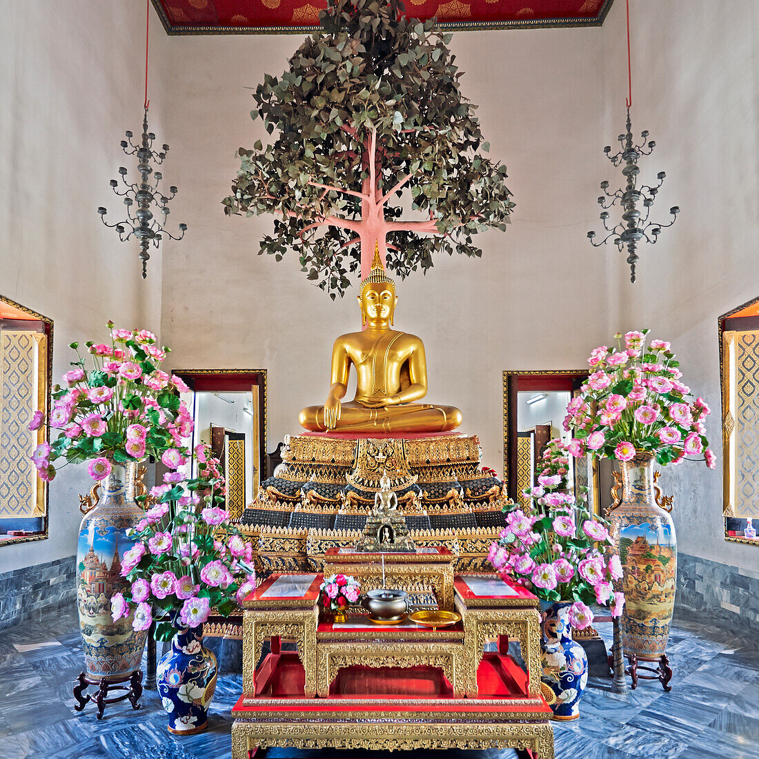 Phra Buddha Maravichai, a seated golden Buddha image in the East Assembly Hall at Wat Pho Temple in Bangkok, Thailand.