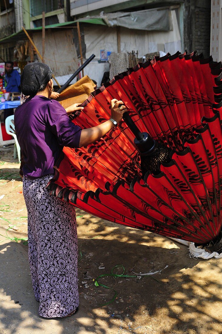 A woman with a red sunshade