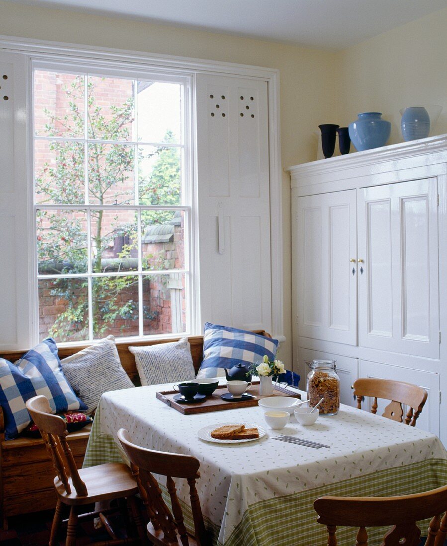 A comfortable dining room by a window in a country house