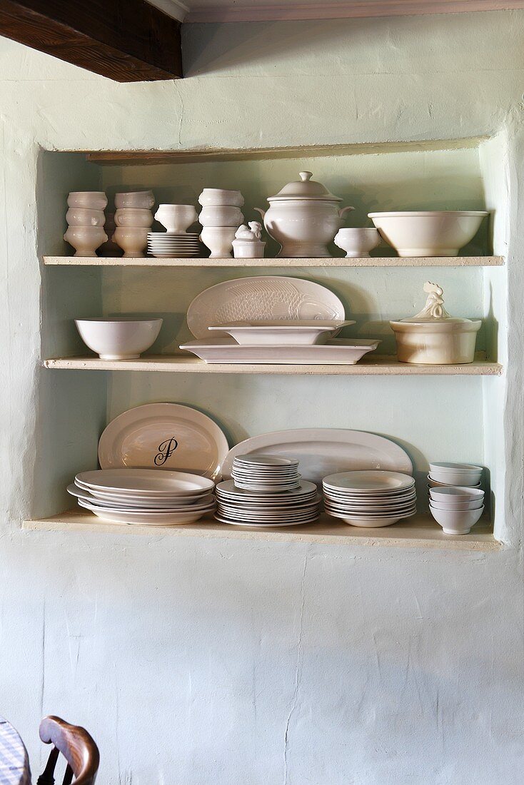 Crockery on a shelf in a wall niche