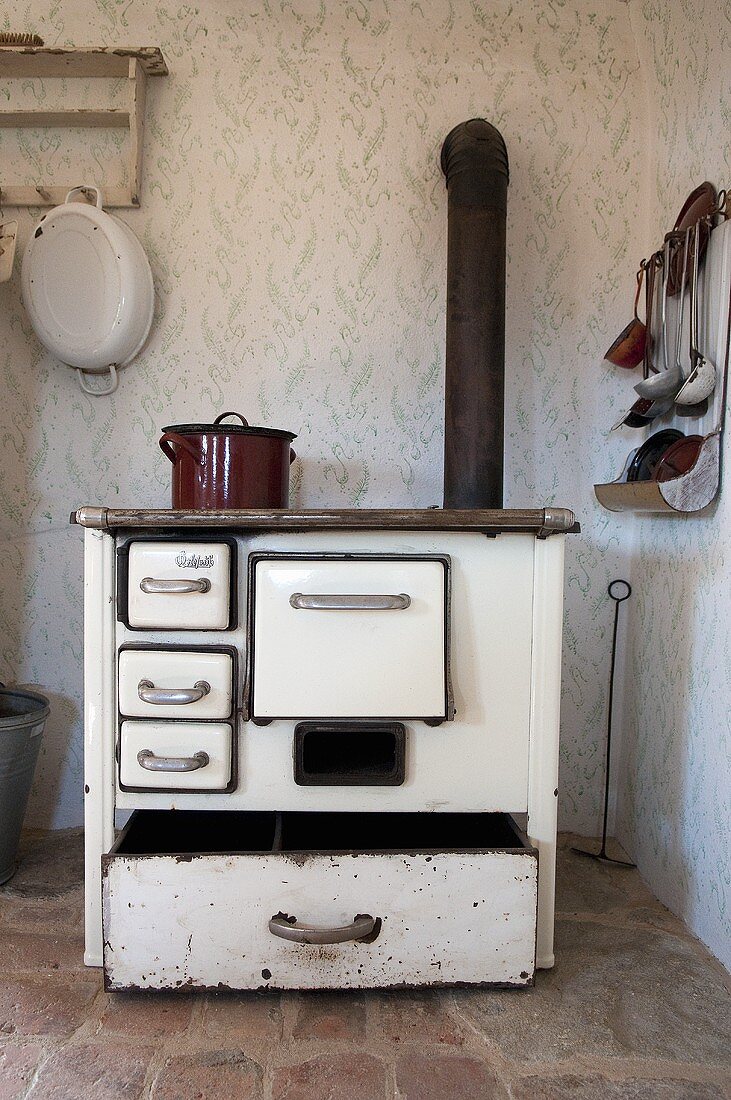 Alter Holzherd mit Ofenrohr in einer Küchenecke