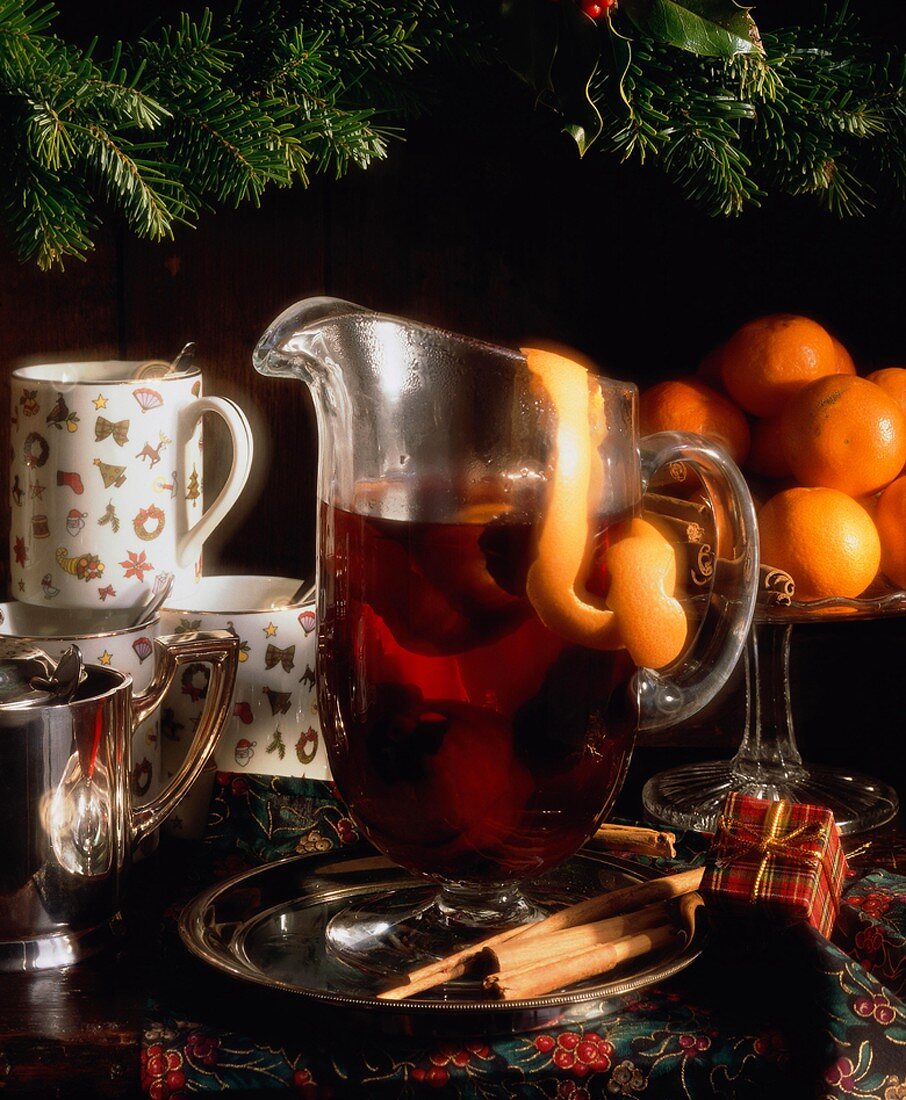 Mulled Wine in Glass Pitcher with Lemon Peel