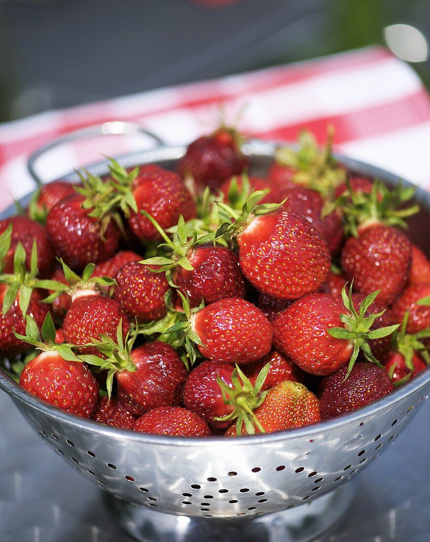 Fresh strawberries in a colander