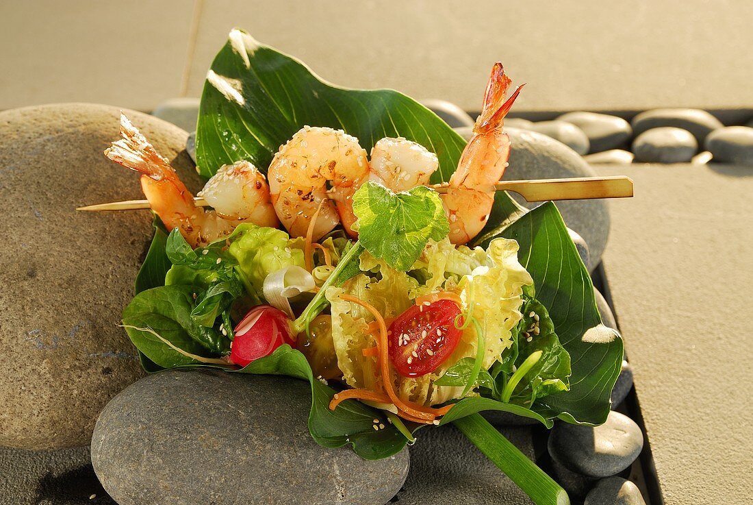 Salad leaves with prawn skewer and Asian dressing