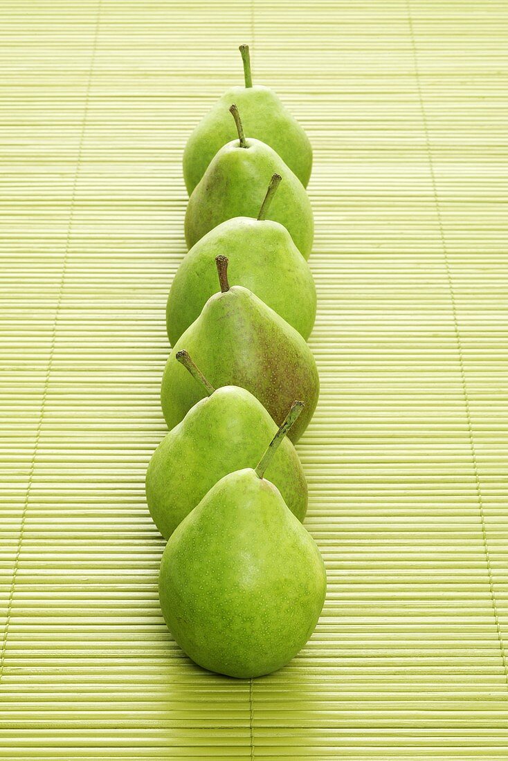 Six pears on a bast mat