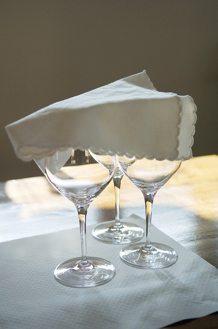 Three wine glasses covered with a napkin